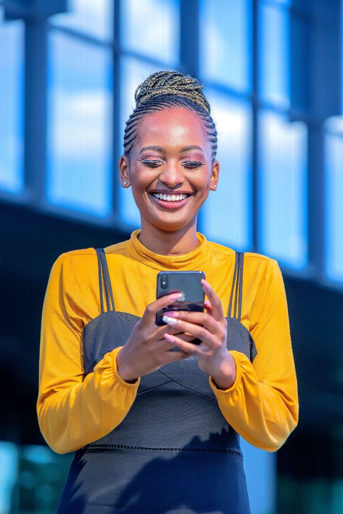 A customer smiling at a payment on her phone
